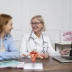 Patient holding tablet with female reproductive system