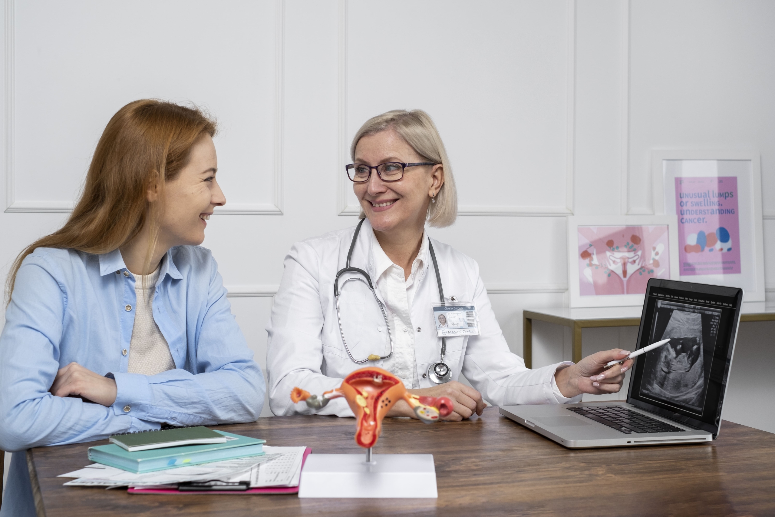 Patient holding tablet with female reproductive system