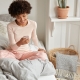 A lady sitting on a bed and enjoying recreation time after uterine fibroid embolisation