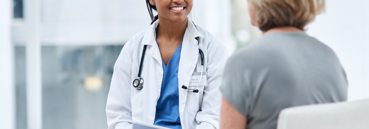 A female doctor discussing UFE and menopause with a mature patient