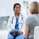 A female doctor discussing UFE and menopause with a mature patient