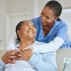 A young doctor comforting an elderly patient to help in understanding UFE success rates