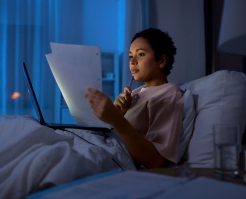 A young lady lying in a hospital bed weighing up her options between UFE vs HIFU