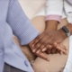 A closeup of a doctor holding a patient’s hand while discussing UFE and IUD safety