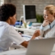 A young woman sitting with a nurse at a clinic and reviewing minimally invasive treatments for uterine fibroids